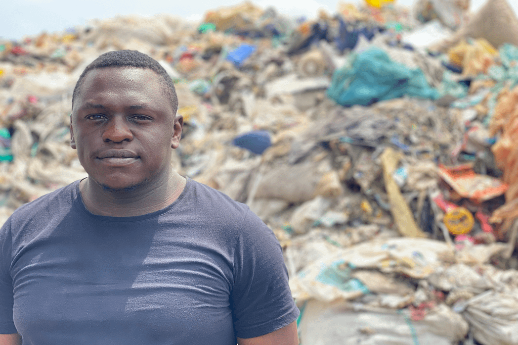 Man standing next to a landfill