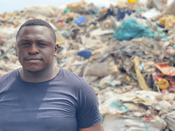 Man standing next to a landfill