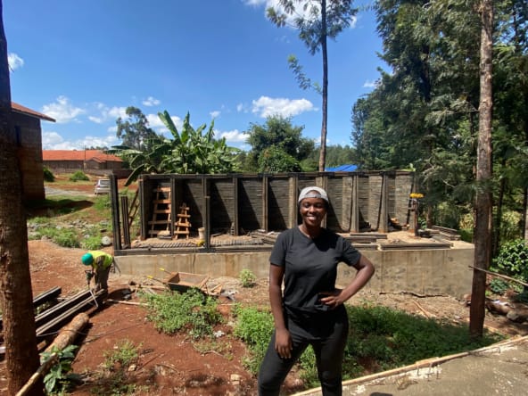 Sustainability: Woman standing at a construction site using sustainable building materials