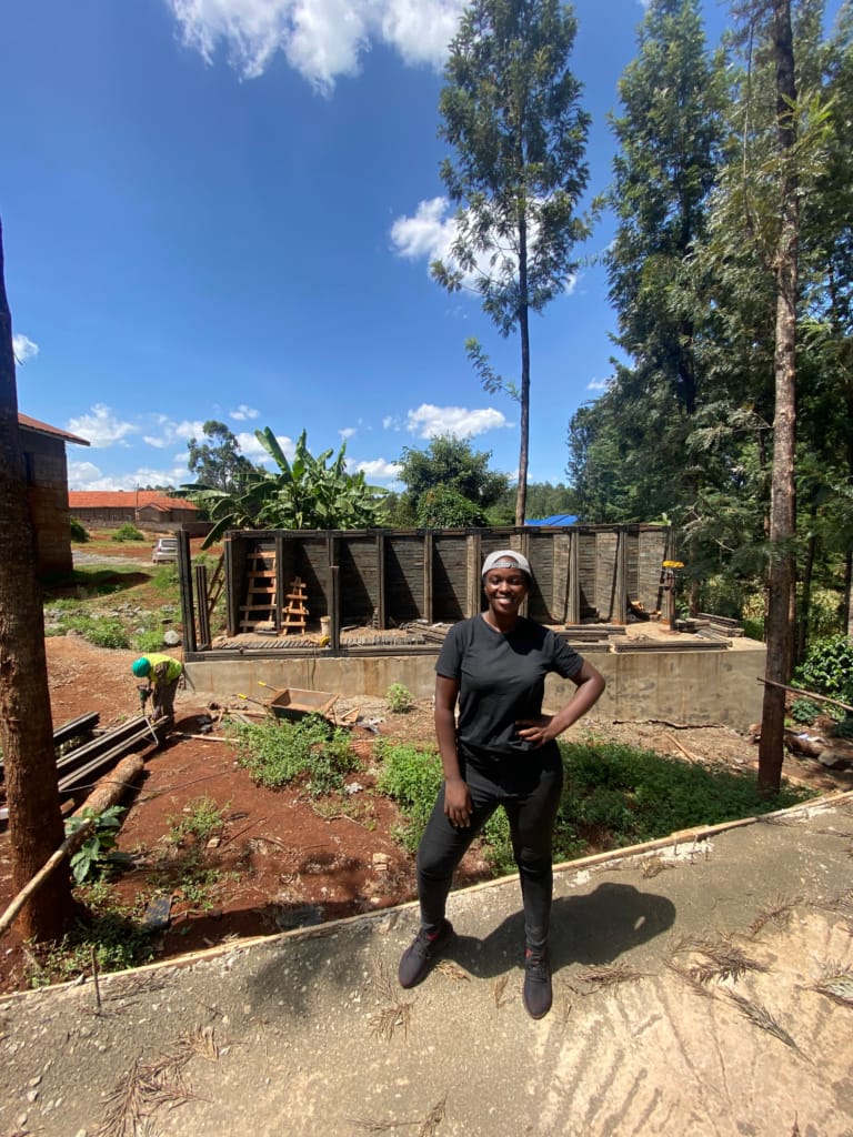 Sustainability: Jean James, Timao Group Co-Founder, standing at a construction site using sustainable building materials